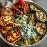 Bright grilled bell peppers and zucchini add color to the Healthy Grilled Mediterranean Bowl, finished with briny olives and a cool yogurt drizzle.