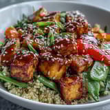 Tender-crisp broccoli, bell pepper, and carrots create a colorful Quinoa Vegetable Teriyaki Bowl, perfect for easy weeknight vegan dinners.