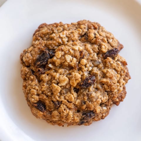 Freshly baked oatmeal raisin cookies, boasting a delightful blend of spices, ready for a delicious dessert.