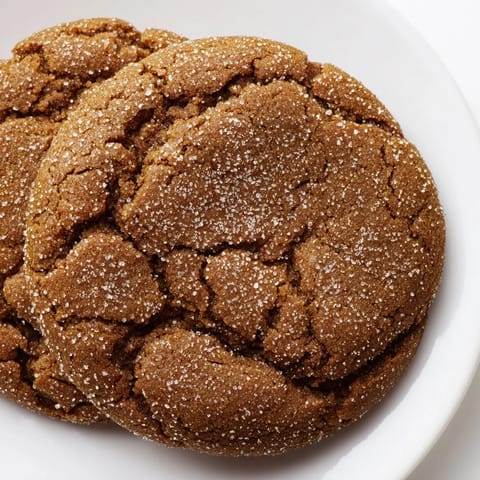 Warm, chewy molasses cookies, golden brown and coated in sparkling sugar, fresh from the oven.