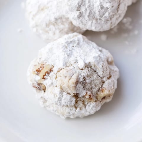 Melt-in-your-mouth Mexican Wedding Cookies perfect for a festive occasion, generously dusted with sugar.