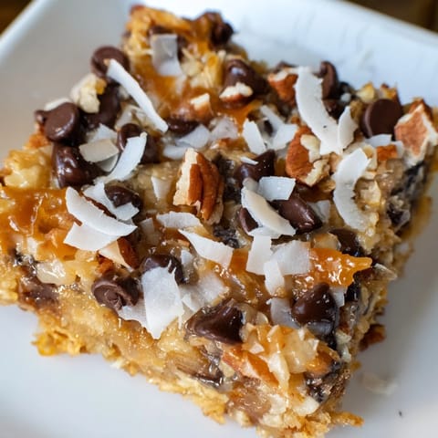 Warm, golden Magic Cookie Bars fresh from the oven, layered with chocolate and coconut.