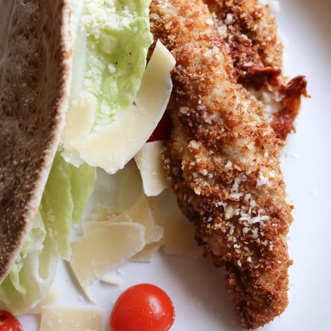 Golden crispy chicken strips, fresh romaine, and creamy Caesar salad stuffed into a warm pita bread pocket.  