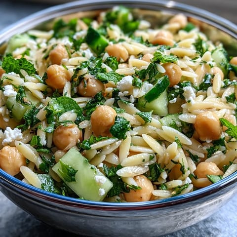 Vibrant Lemony Chickpea Orzo Salad, a healthy Mediterranean dish perfect for lunch.